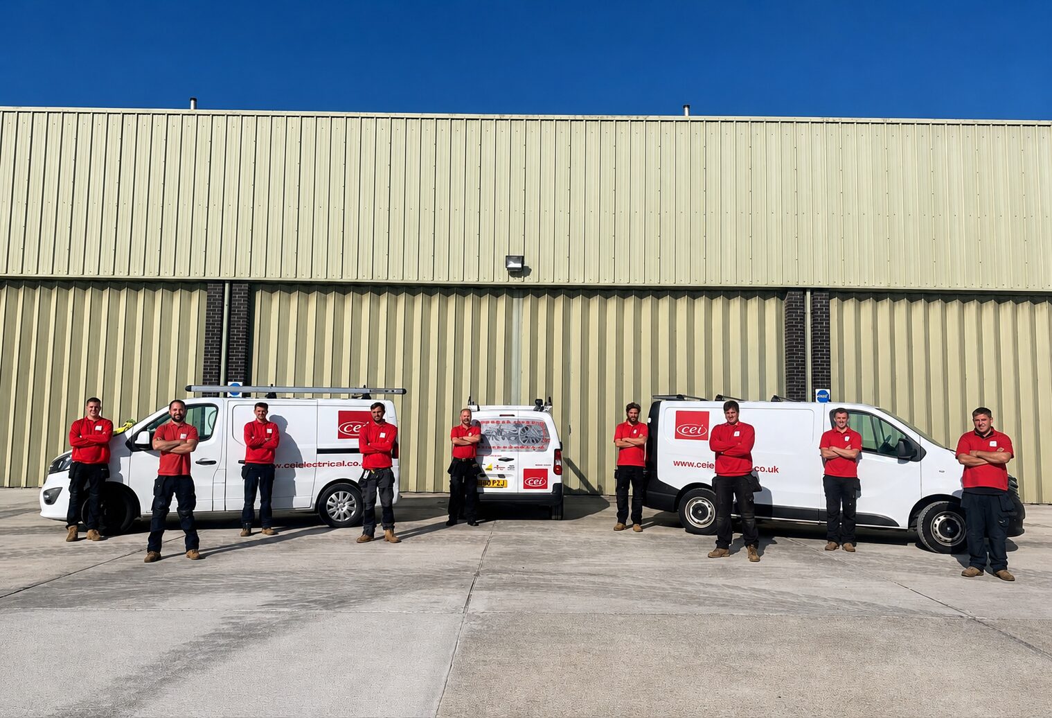 The CEI team with their vans outside the workshop
